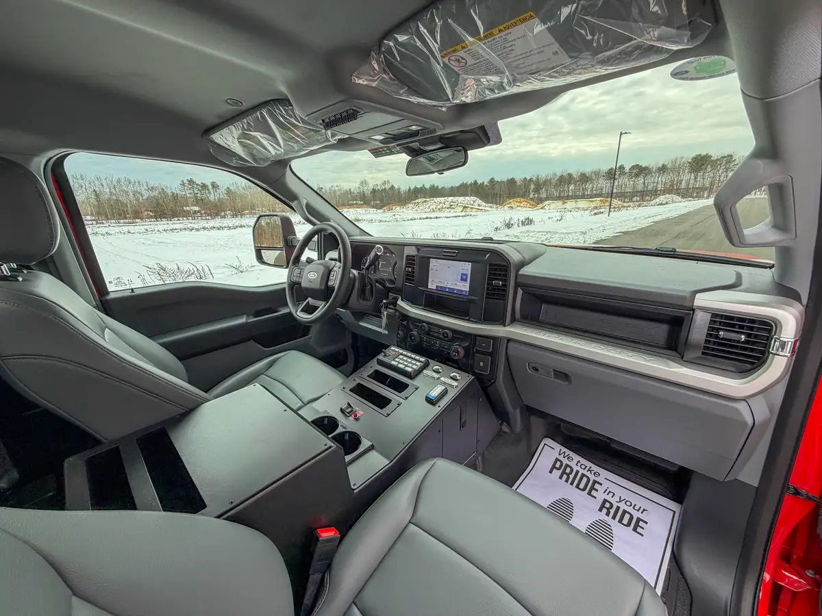 Wide interior view across dashboard and front seating row.